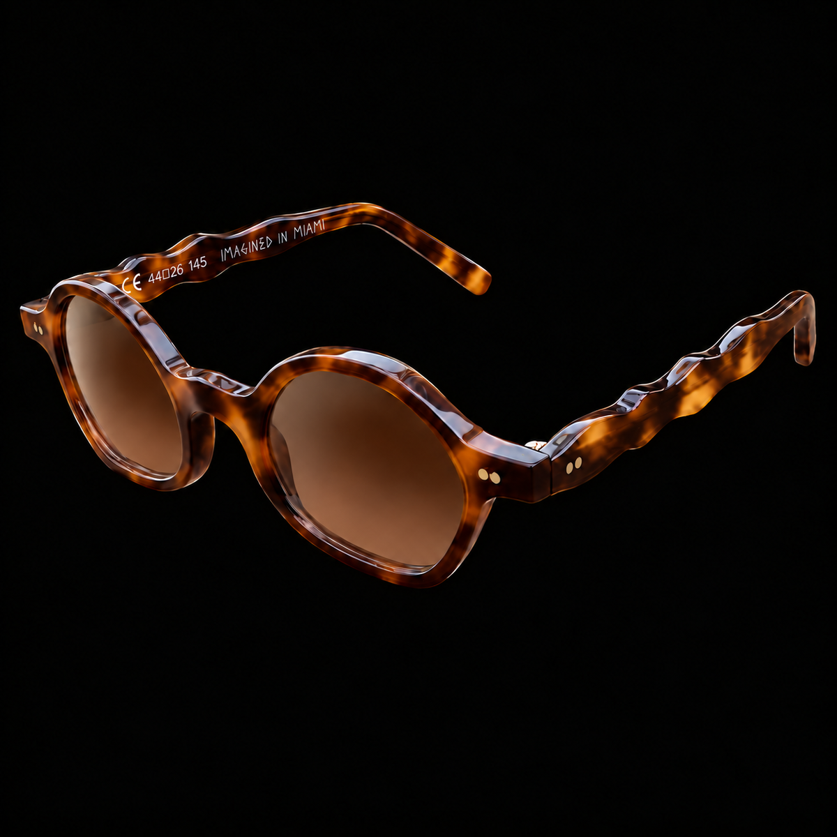 MARCEL Scholar Study 06220 brown tortoiseshell sunglasses with brown lenses, three-quarter view on black.