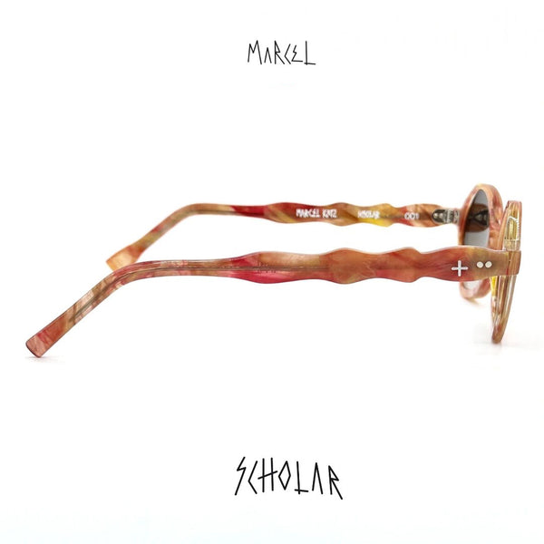 Marcel sunglasses with colorful frame and 'Scholar' text on a white background. Side profile view.