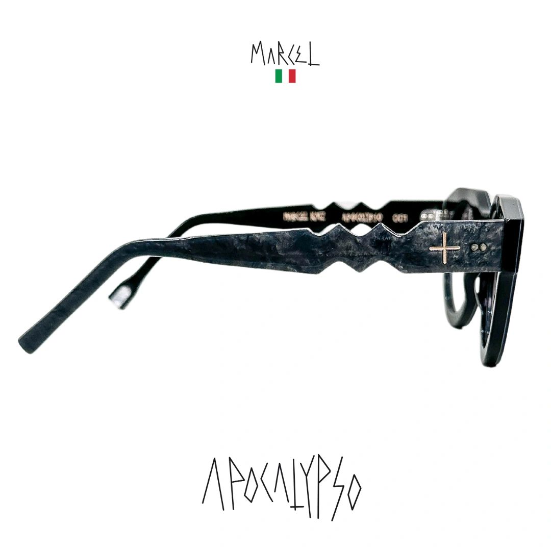 Black sunglasses with 'Marcel' branding on a white background. Profile view.