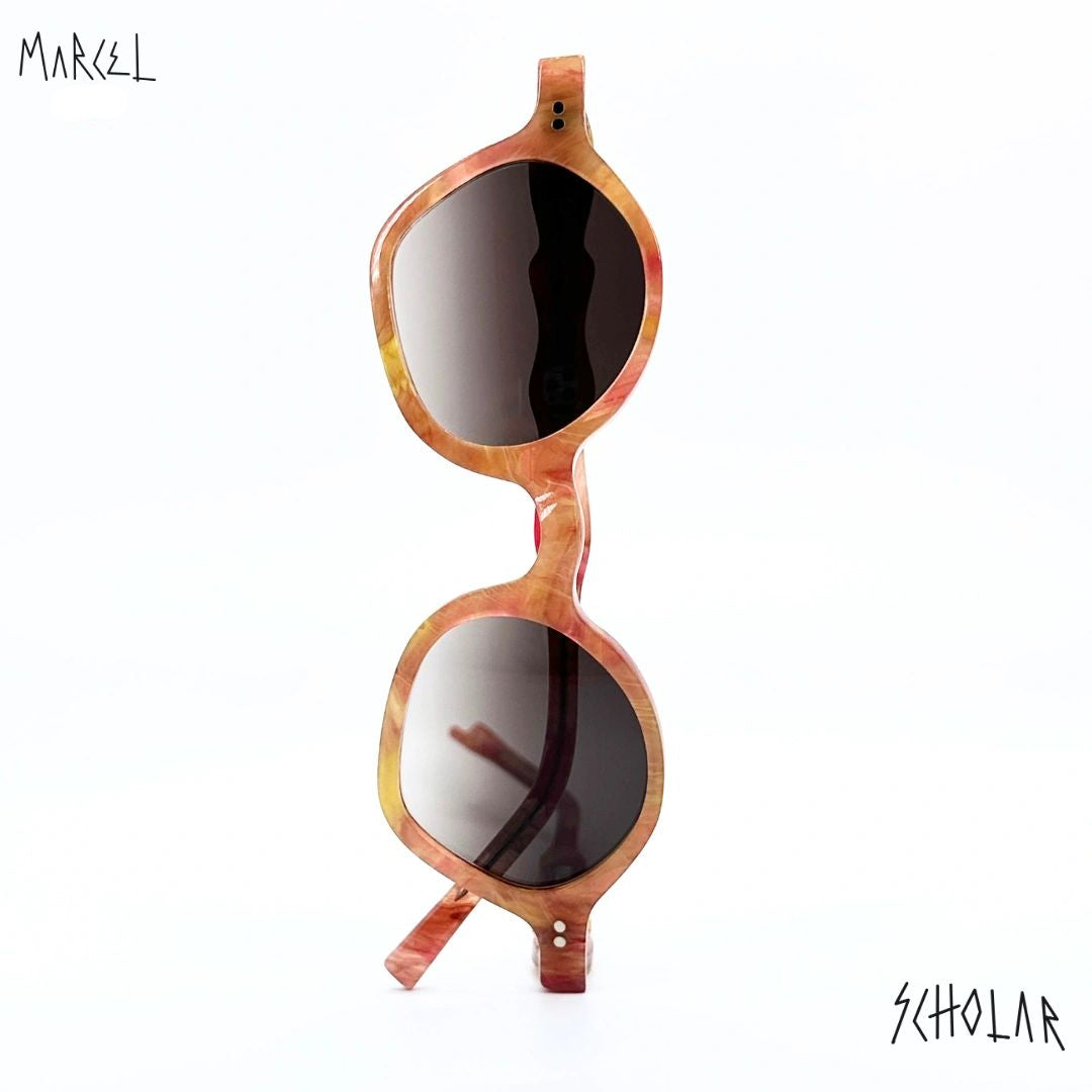 Sunglasses with tortoiseshell frame and dark lenses on a white background, branded 'Marcel'. Front view.