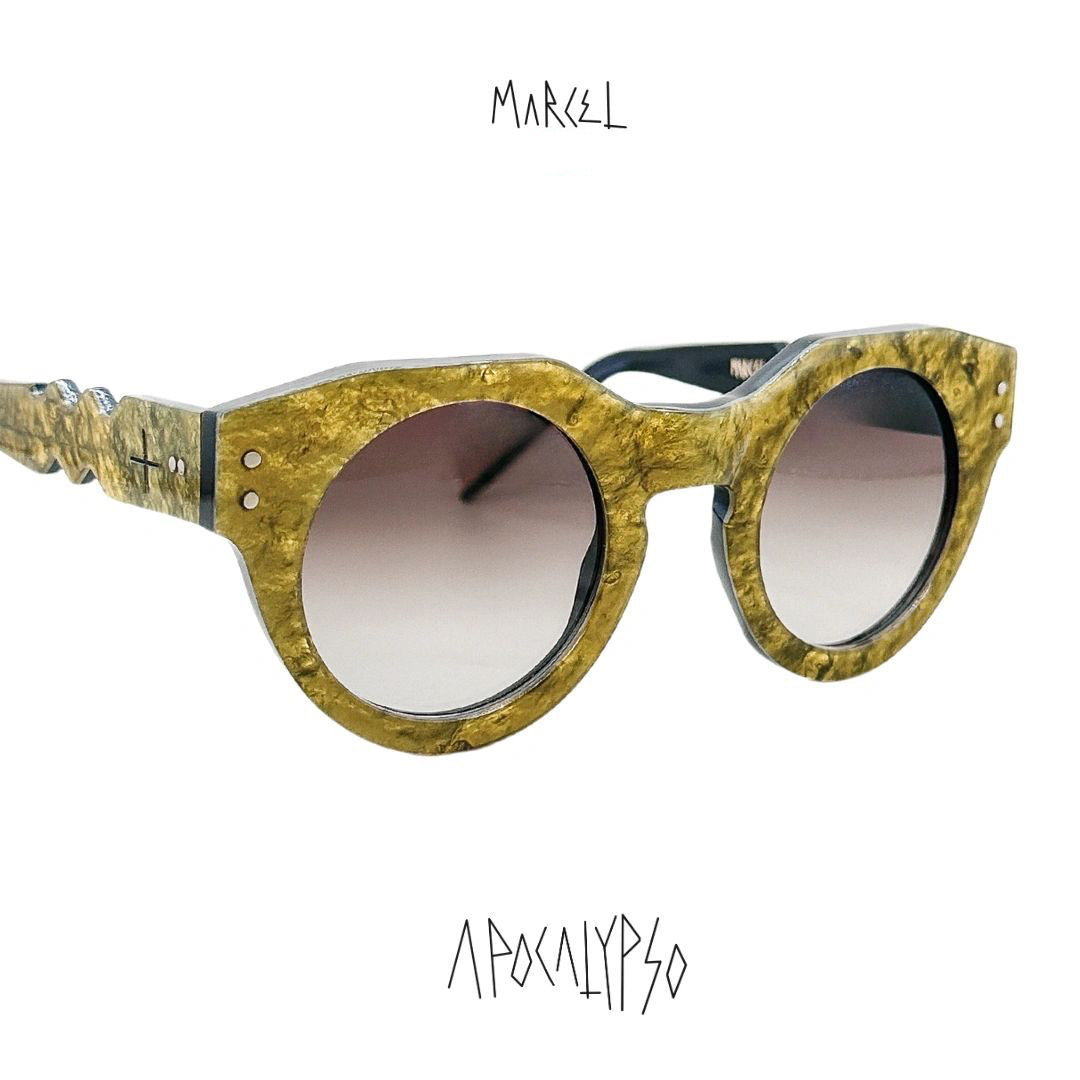 Gold-framed sunglasses with gradient lenses on a white background, featuring the brand 'Marcel'. 3/4 front view.