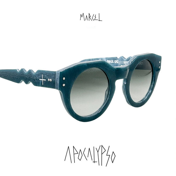 Blue sunglasses with a white background and 'Marcel' brand logo. 3/4 front view.