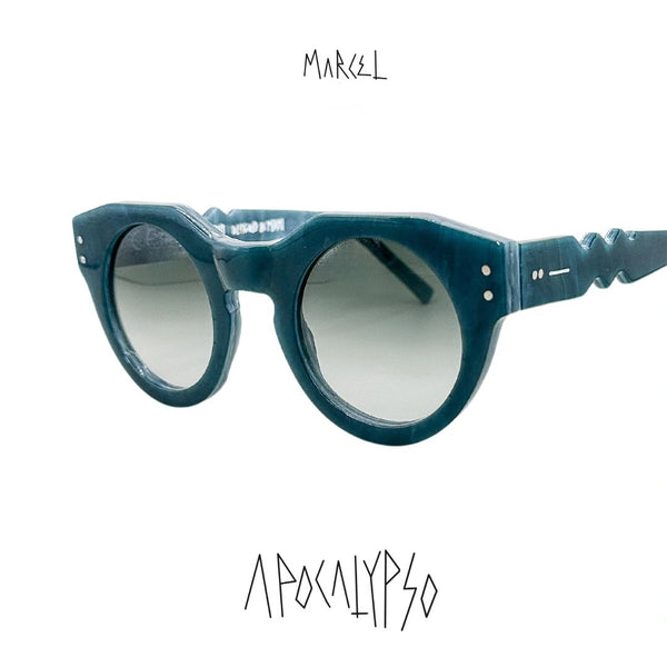 Blue sunglasses with gradient lenses on a white background, featuring the brand 'Marcel'. 3/4 front view.