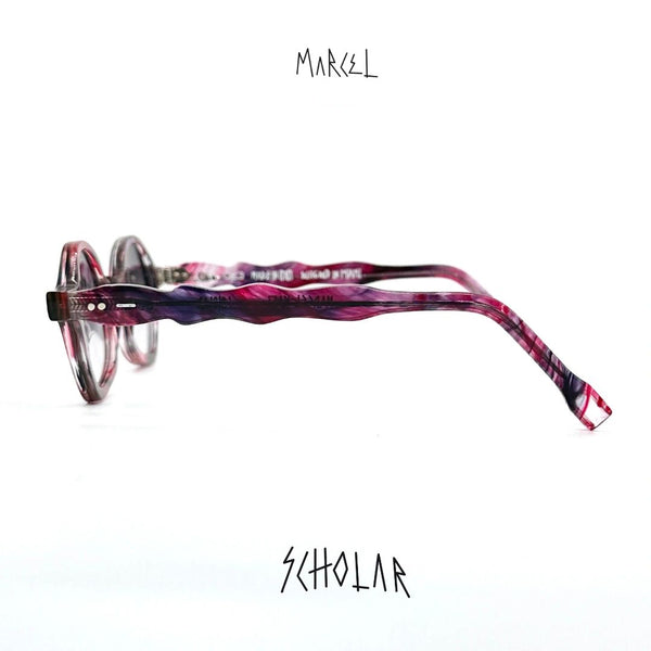 Marcel glasses with pink and purple design on a white background. side profile view.