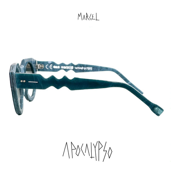Teal eyeglasses with 'Marcel' branding on a white background. Profile view.