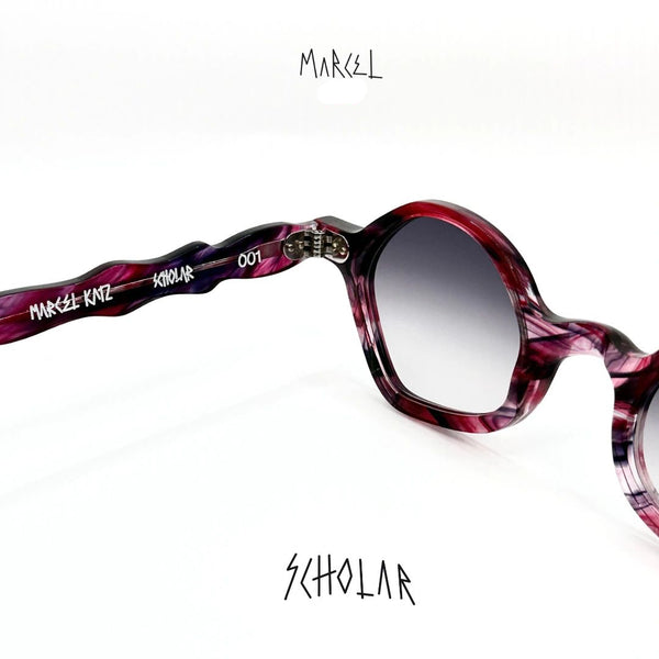 Marcel Katz Scholar sunglasses with a purple frame on a white background. 3/4 back view.
