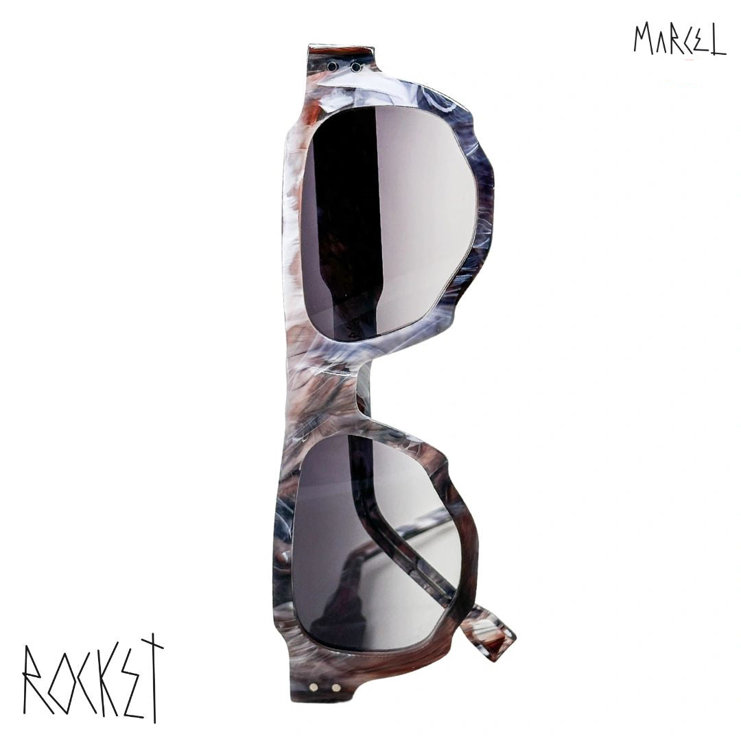 Marbled sunglasses with reflective lenses on a white background, featuring the brand 'Marcel' and 'Rocket'. Front view.