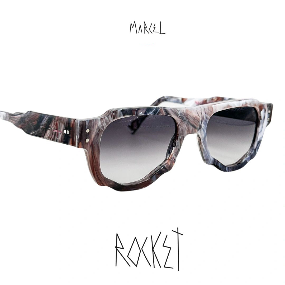 Marbled sunglasses with gradient lenses on a white background, featuring the brand 'Marcel'. 3/4 front view.