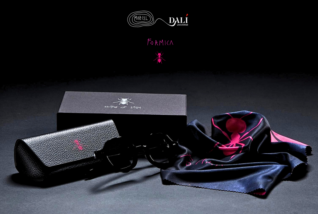 A luxury eyewear set by DALI, featuring a black textured leather case, a pair of black sunglasses, a black silk scarf with a vibrant pink lining, and the branded black packaging box on a dark studio background.