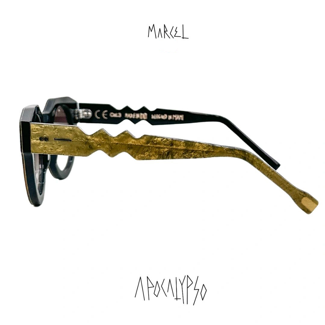 Sunglasses with gold and black frame on a white background, featuring the brand 'Marcel'.