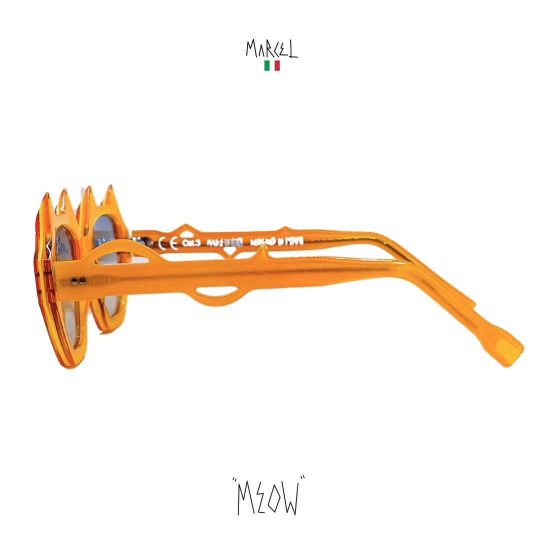 Orange sunglasses with a unique frame design on a white background, featuring the brand 'Marcel' and 'Meow'. Profile view.