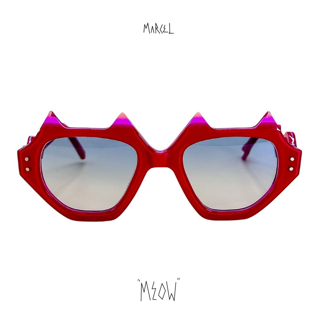Red sunglasses with spike-like design on a white background, featuring the brand 'Meow'. Front view.