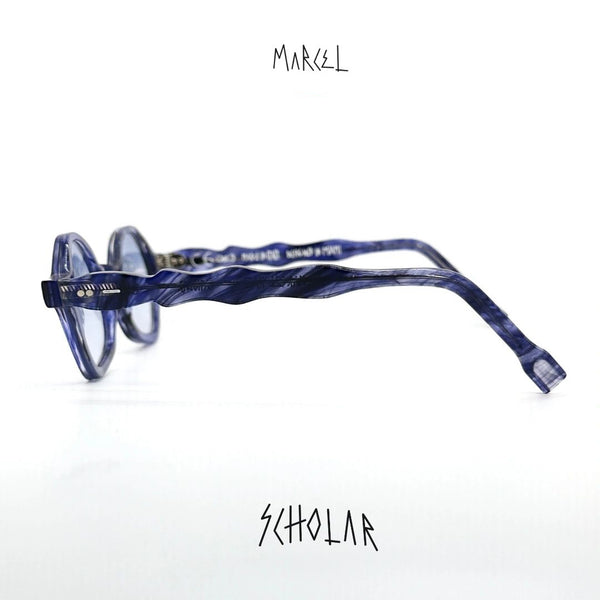 Blue eyeglasses with 'Marcel' branding on a white background. Side profile view.