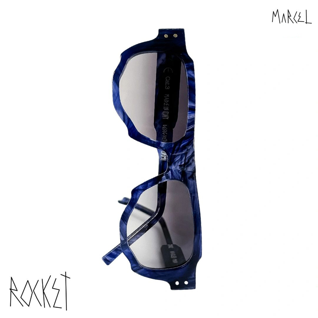 Blue sunglasses with reflective lenses on a white background, featuring the brand 'Marcel'. Front view.