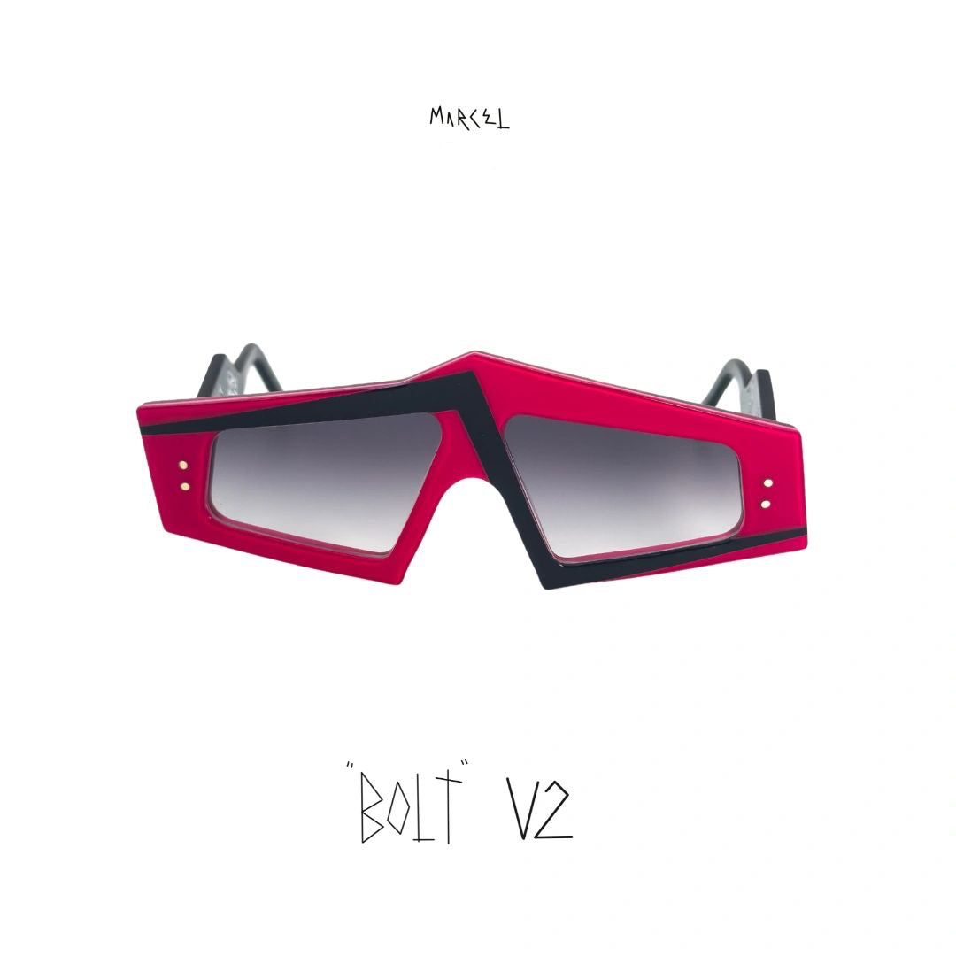 Sunglasses with pink and black frame on a white background, featuring the brand 'Marcel'. Front view.