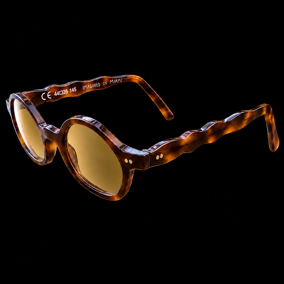 MARCEL Scholar Study 06220 brown tortoiseshell sunglasses with amber lenses, three-quarter view on black.